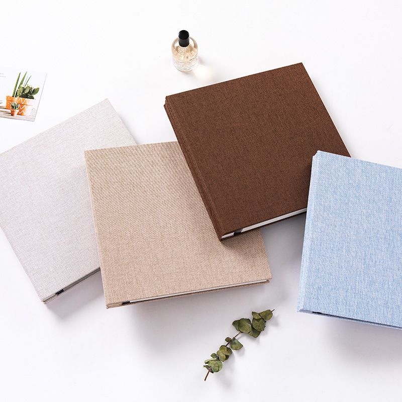 Four MYKEEPO linen albums in natural, sand, chocolate and sky blue