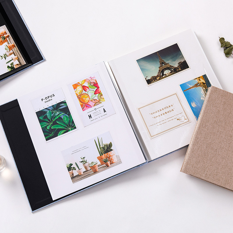 A MYKEEPO linen album opened flat showing printed photo pages