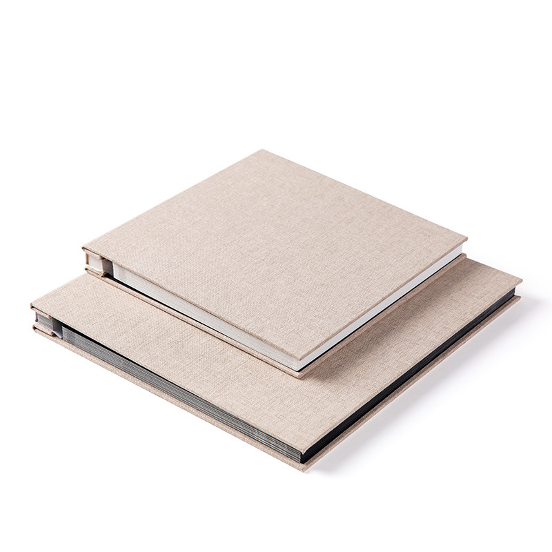 Standard and large MYKEEPO linen albums stacked to compare sizes